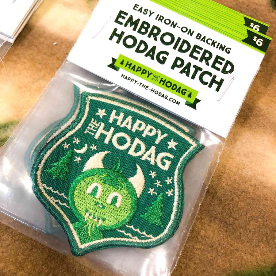 Forest green embroidered happy the Hodag patch in packaging that reads easy iron-on backing embroidered Hodag patch