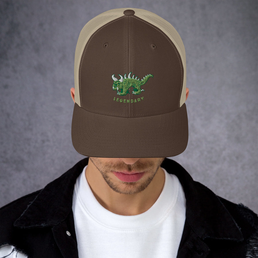 Brown and tan trucker cap with two tone green and white vintage embroidered Hodag with the word legendary underneath.