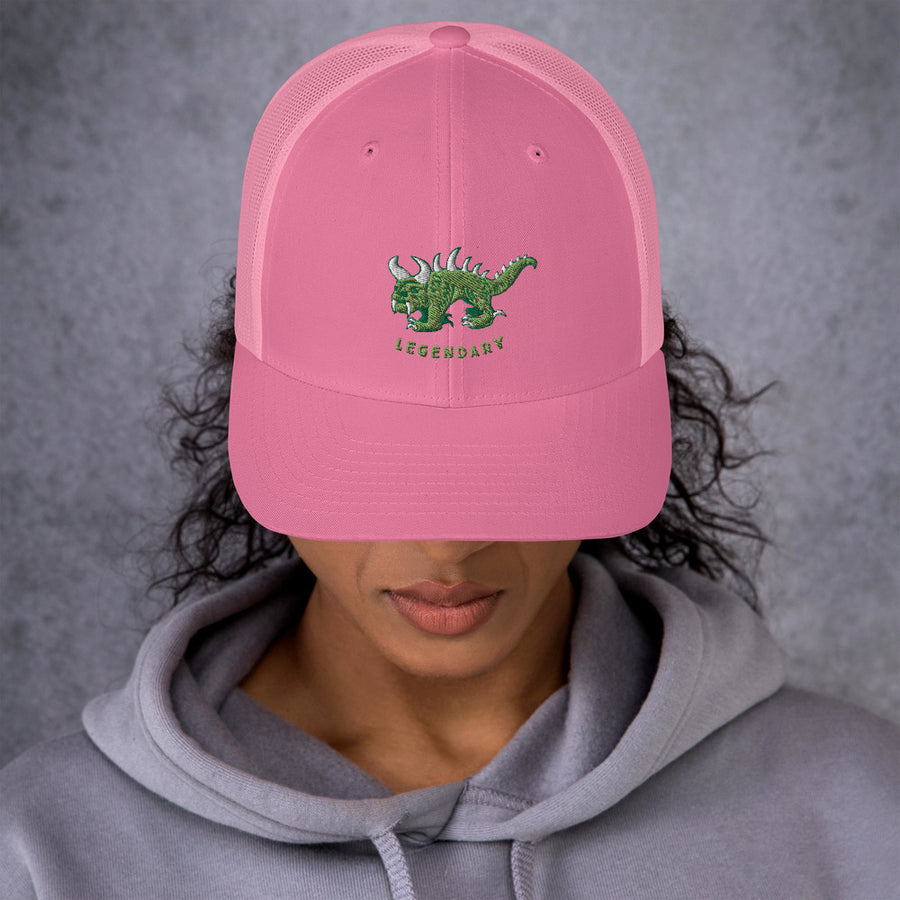 Pink trucker cap with two tone green and white vintage embroidered Hodag with the word legendary underneath.
