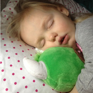 A little girl sleeping with her Happy the Hodag Plush Toy